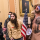 QAnon rioters including Jacob Chansley, better known as the "Q Shaman," confront U.S. Capitol police near the Senate Chamber in the Capitol on Jan. 6.
